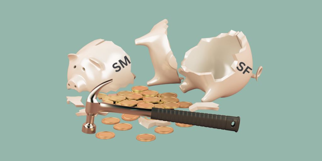 A smashed piggy bank with the letters "SMSF" on the side, lies in pieces. In front of it lays a pile of coins and a hammer.